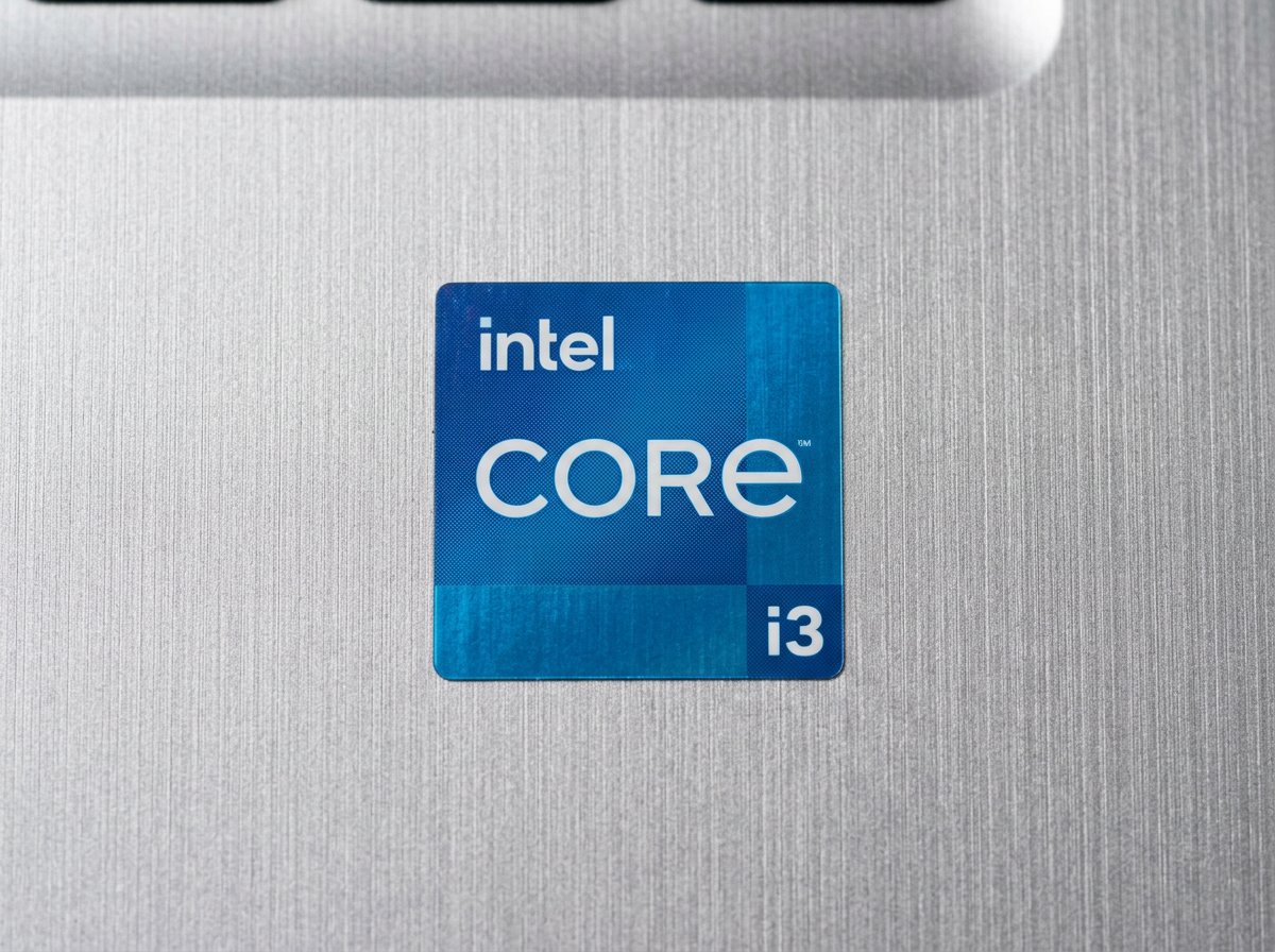 Intel Core i3 processor badge sticker on laptop palm rest — entry-level badge for web and documents